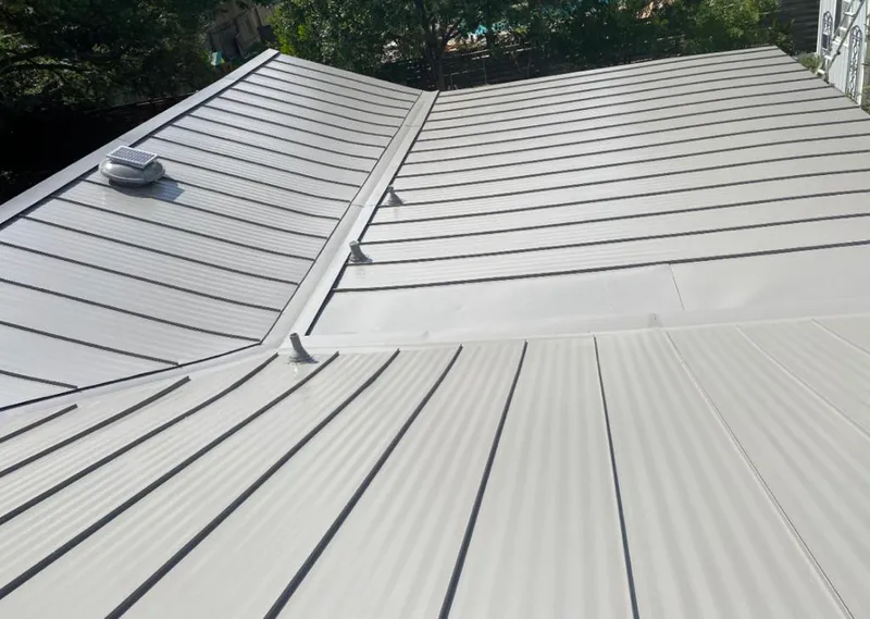 Solar attic fan installed on a metal roof for Roof Ventilation in Friendly